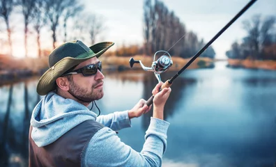 Fototapeten Fisherman enjoys in fishing on the river. Sport, recreation, lifestyle © bobex73