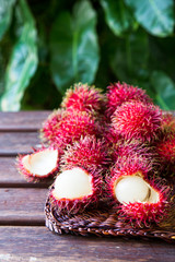 Fresh ripe rambutans on wooden background. Delicious rambutan sweet fruit