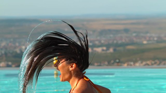 Woman throwing hair back in pool