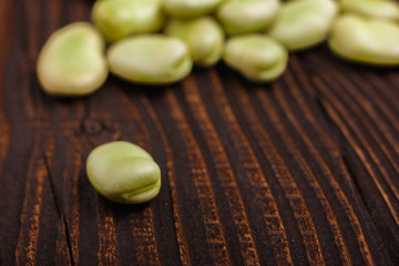 fresh broad beans on a rustic background