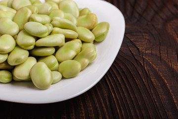 fresh broad beans on a rustic background