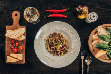top view of pasta with meat on dark table