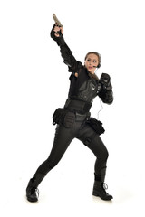Fototapeta premium full length portrait of female soldier wearing black tactical armour, holding a gun, isolated on white studio background.