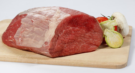 fresh raw red beef meat big steak chunk on wooden cut board isolated over white background