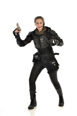 full length portrait of female  soldier wearing black  tactical armour, holding a gun, isolated on white studio background.