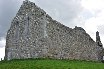 Ruins of medieval stone Christian church called Temple Melaghlin in Clonmacnoise in Ireland.