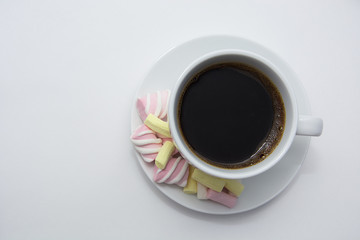 A cup of fragrant coffee with a colorful marshmallow.