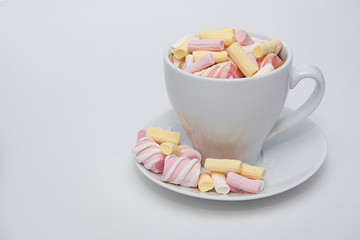 A cup of fragrant coffee with a colorful marshmallow.