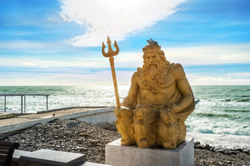 Желтая скульптура Нептуна на берегу Черного моря в Сочи Yellow sculpture of Neptune © yulenochekk