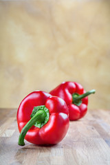 fresh red bell pepper lying on the oak chopping Board