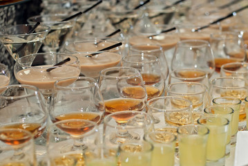 Glass glasses with colored drinks on the table