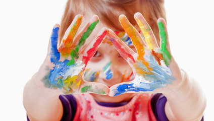 Beautiful little child girl with colorful painted hands.