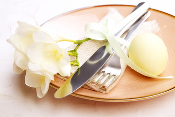 Easter laying table appointments, table setting options. Silverware, tableware items with festive decoration. Fork, knife and flowers. Happy easter holiday.