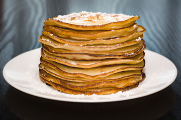 Pancakes in powdered sugar.