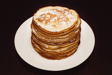 Pancakes in powdered sugar.