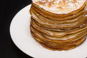 Pancakes in powdered sugar.