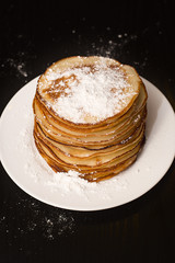 Pancakes in powdered sugar.
