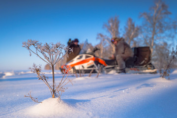 Man on snowmobile. Recreation concept on nature in winter holidays. Winter sports. driver of a snowmobile is blurred in the background