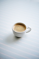 Coffee on the white table with light rays