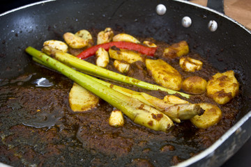 Lemongrass and ginger in a frying pan fried in hot sauce