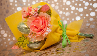 Bouquet of cloth flowers with chocolate eggs