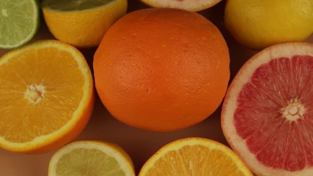 Oranges, grapefruit, lemon and lime on a beige plate