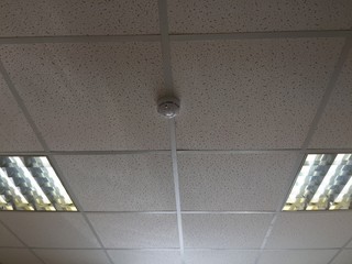 A ceiling with a smoke detector