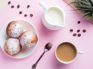Breakfast muffins coffee milk jug on a pink background. Top view Flat lay