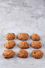 Sweet biscuits arranged in pattern on light textured background, close-up, shallow depth of field, selective focus.
