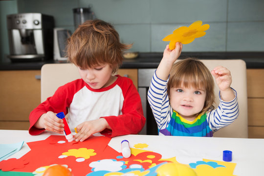 ?ute Preschool Children Prepare Together Paper Decor. Tools And Materials For Children's Art Creativity On Table.  Easter Decor.