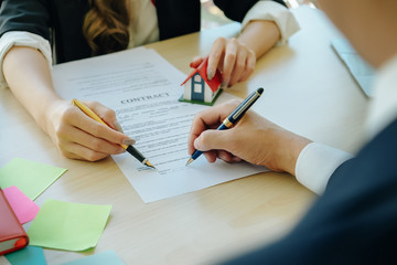 Agreement paper,estate agent gives pen and documents agreement with customer to sign contract.