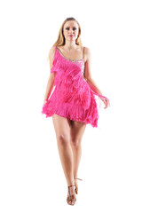 Front view of blonde woman in fringed dress walking and looking at camera. Full body length portrait isolated on white studio background. 