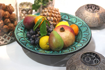 green oriental plate with fruits, still life