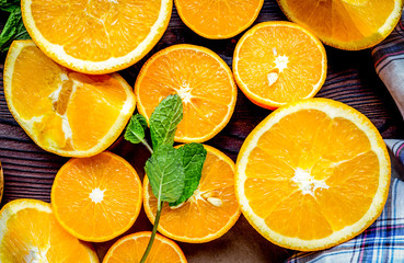 Orange juice making from fruit and mint on kitchen table top vie