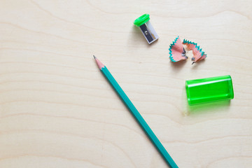 Colour pencils on wooden background. Some amount