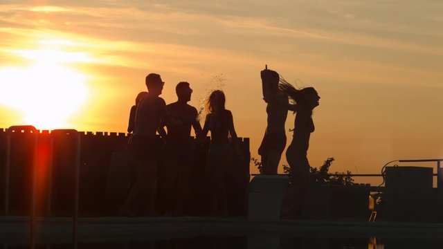 Contre jour of young people partying at sunset