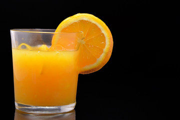 Orange juice on black background