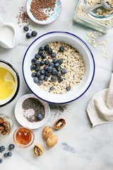 Super seedy vegan baked oatmeal with blueberries and walnuts. Power breakfast for healthy, super food and clean eatind concept. Overhead view