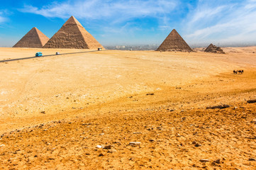 The Egyptian pyramids of Giza on the background of Cairo. Miracle of light. Architectural monument....