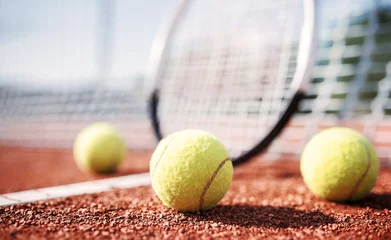 Rolgordijnen Tennis ball with racket on the tennis court. Sport, recreation concept © bobex73