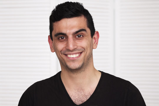Young happy middle eastern man smiling