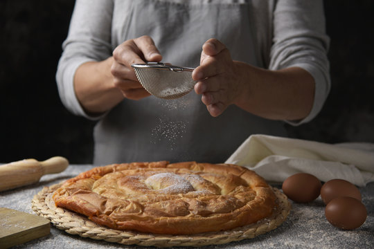 man preparing ensaimada typical of Mallorca, Spain