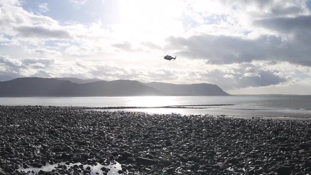 Rescue Helicopter Flying over Scenic Coast in North Wales