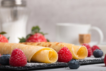 rolled pancakes with fresh fruit and coffee