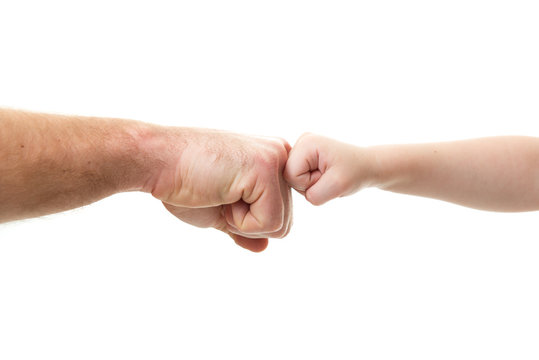 Funny fight. Father's and his son's knuckles. Dad's and kid's hands over white. Male and children hands closep, isolated on white background. Violence in family.