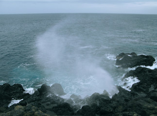Saint Leu / La Reunion: Le Souffleur is a natural phenomenon on the wild rocky coast caused by the repeated onslaught of the sea swell with an impressive jet of sea-spray