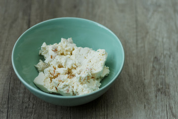 cottage cheese in a green plate is on the table