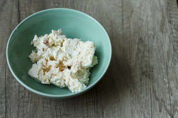 cottage cheese in a green plate is on the table