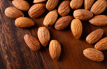 Almond. peeled nuts on textured wooden background. Organic food.