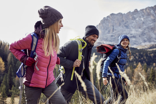 Smiling friends hiking in the mountains